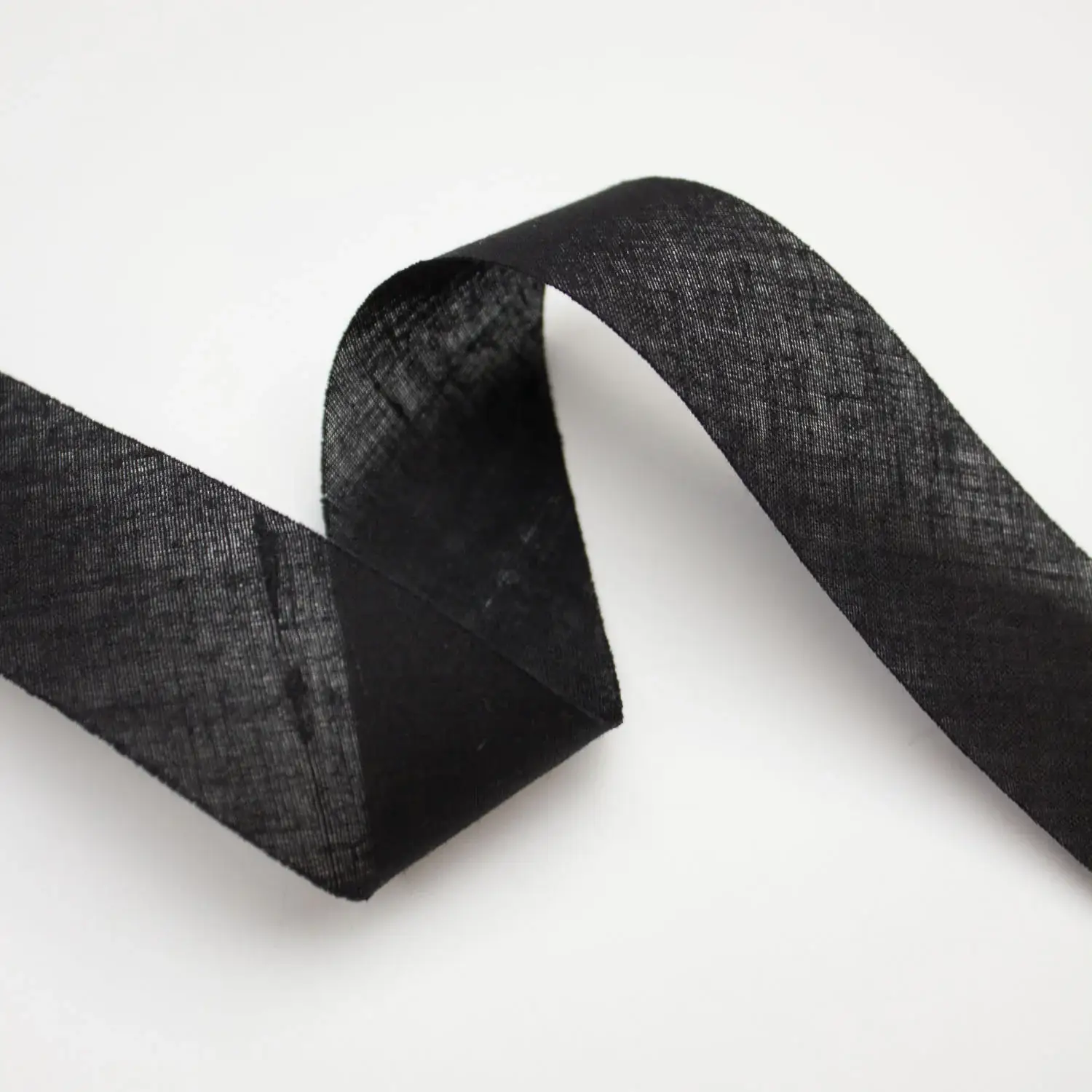 Al Amana General Trading LLC bias‑cut service providing flexible diagonal‑cut tapes for smooth contouring and precise garment finishing.