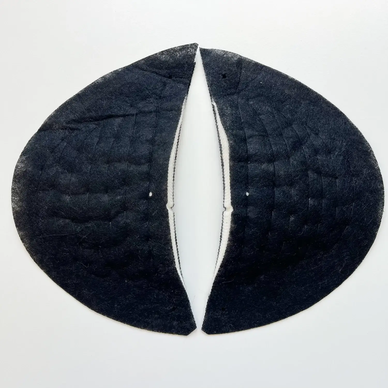 Shoulder pads used in garment shaping to enhance shoulder contour, balance, and structure.